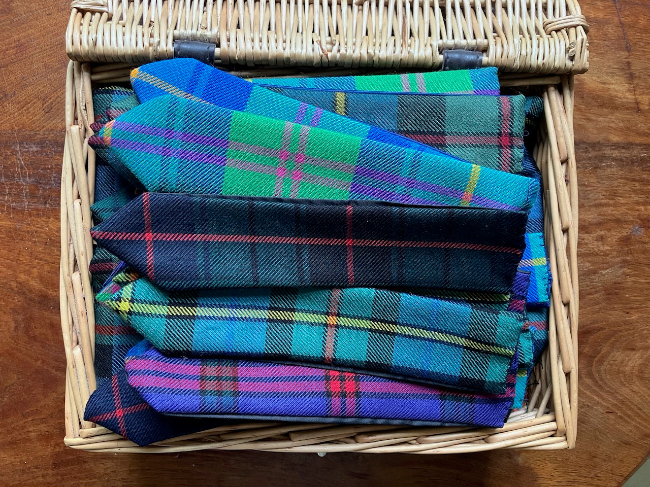Pile of assorted Tartan Bookmarks by Curlew Crafts in a picnic basket