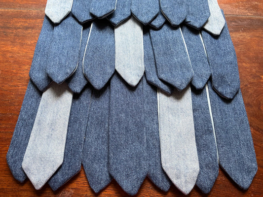 Rows of assorted Denim Bookmarks on a wooden surface