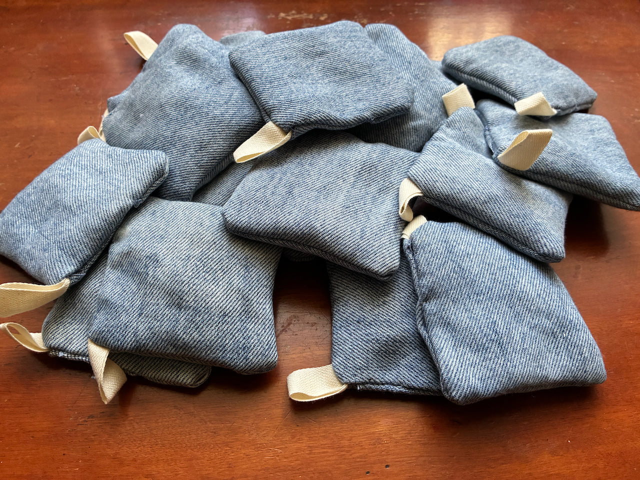 Collection of Blue Denim Clove Sachets on a wooden surface