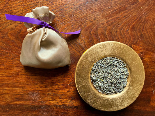 Gold Silk Lavender Sachet with Purple ribbon by a saucer of Dried Lavender