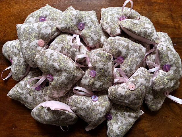 Collection of Grey and Pink Paisley Lavender Sachets on a wooden surface