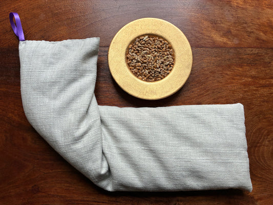 Large Lavender Scented Wheat Bag by Curlew Crafts beside a bowl of wheatgrain