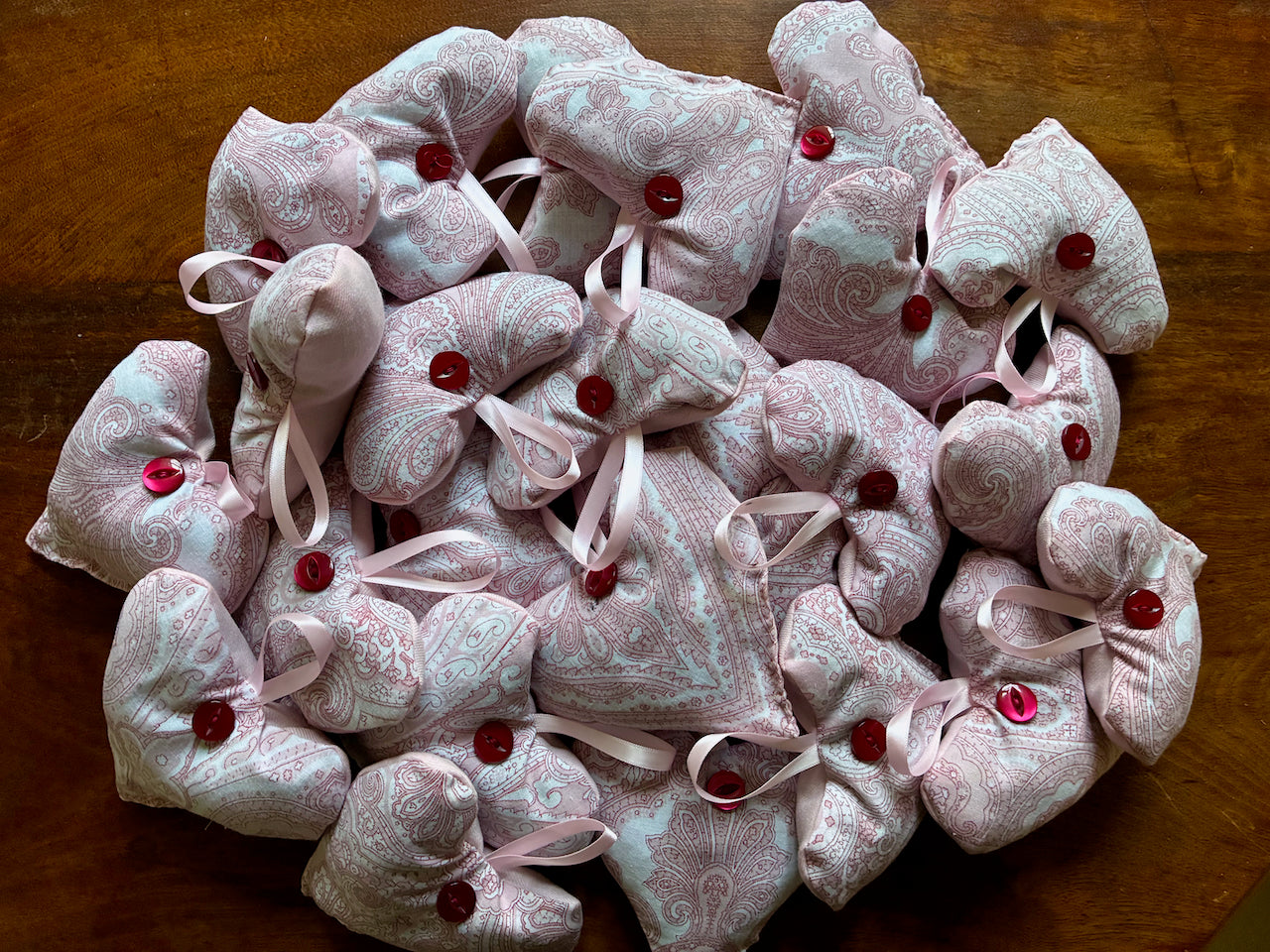 Collection of Red and White Lavender Sachets on a wooden surface