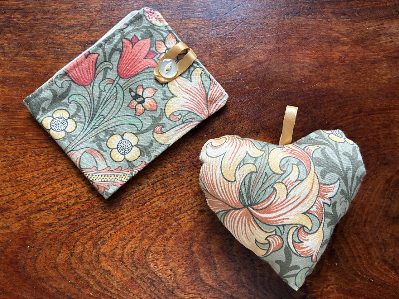 One William Morris Needle Case and Heart Pincushion Set on a wooden surface