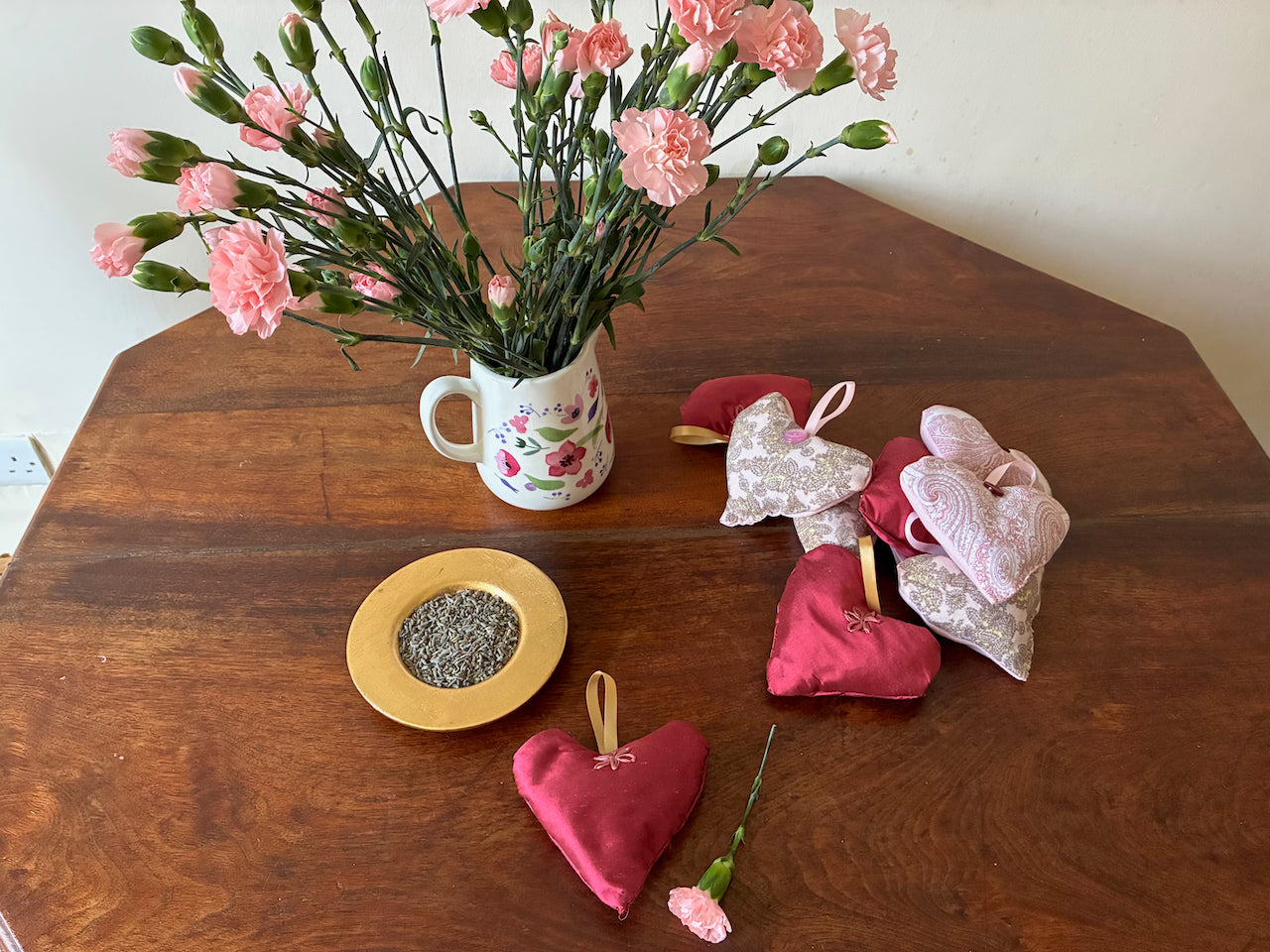 One heart shaped Magenta Lavender Sachet with flowers and a bowl of dried Lavender