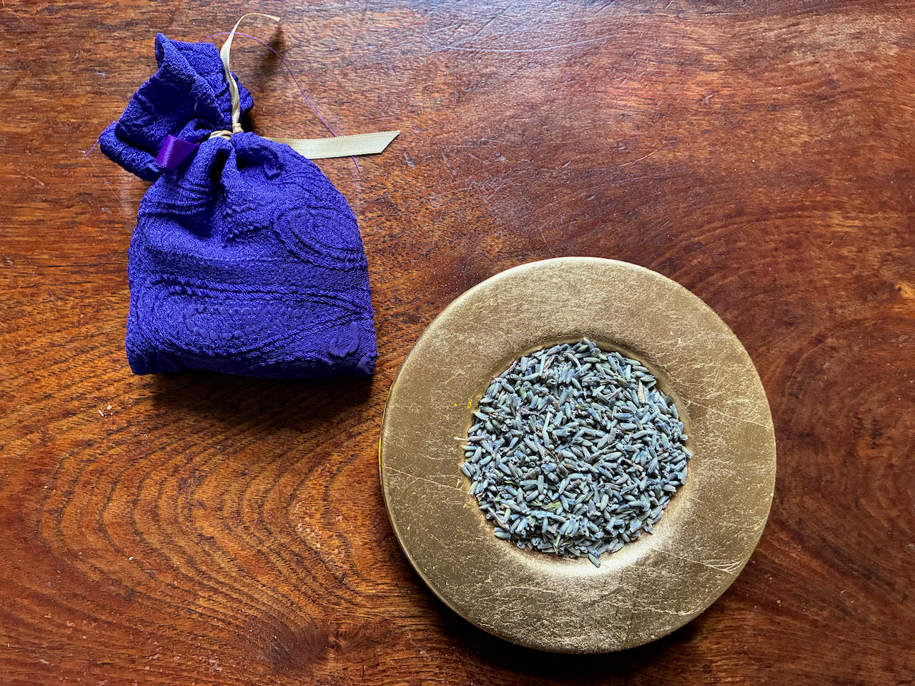 One Purple Lavender Sachet and a saucer of Dried Lavender