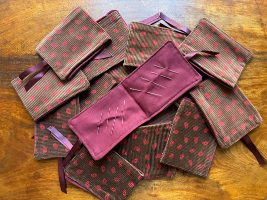 Pile of Paisley Needle Cases with one open by Curlew Crafts