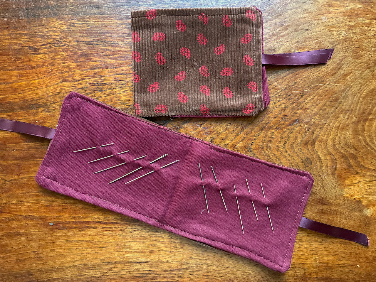 Paisley Needle Cases by Curlew Crafts with  one open with needles and one closed