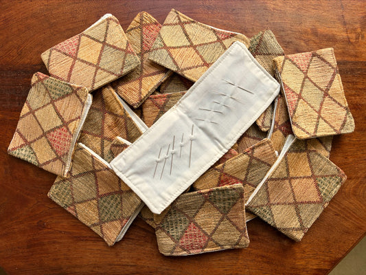 Harlequin Chenille Needle Cases on a wooden table