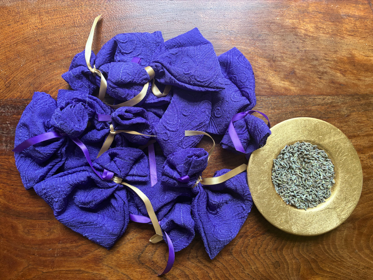 Purple Lavender bags with Gold and Purple ribbons by Curlew Crafts and a Gold saucer of dried Lavender buds.