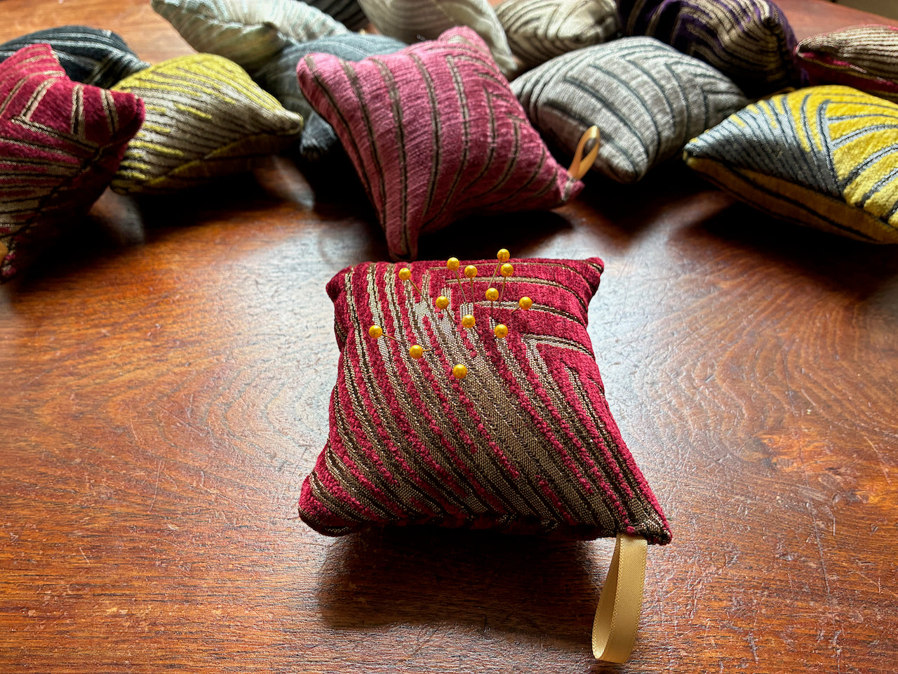 Red Art Deco Chenille Pincushion with Gold Pins among other assorted colours 
