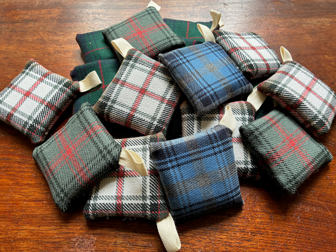 Assorted Square Tartan Clove Sachets on a wooden surface