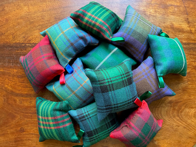 Assorted Tartan Pincushions on a wooden surface
