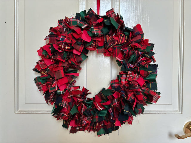 Circular Tartan wreath in Seasonal Reds, Greens and Golds on a white door