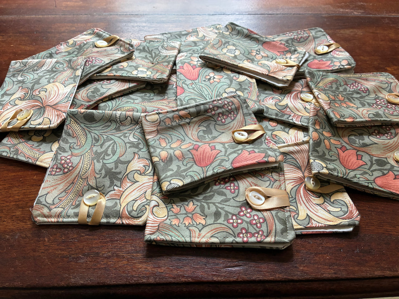 Collection of William Morris Needle Cases on a wooden surface