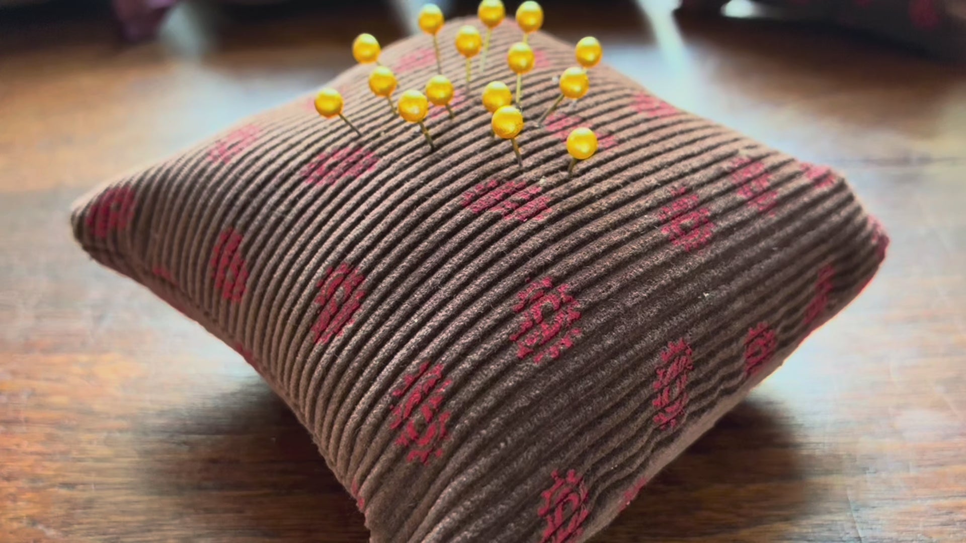 A single Chestnut and Rose Paisley Pincushion by Curlew Crafts, with pins