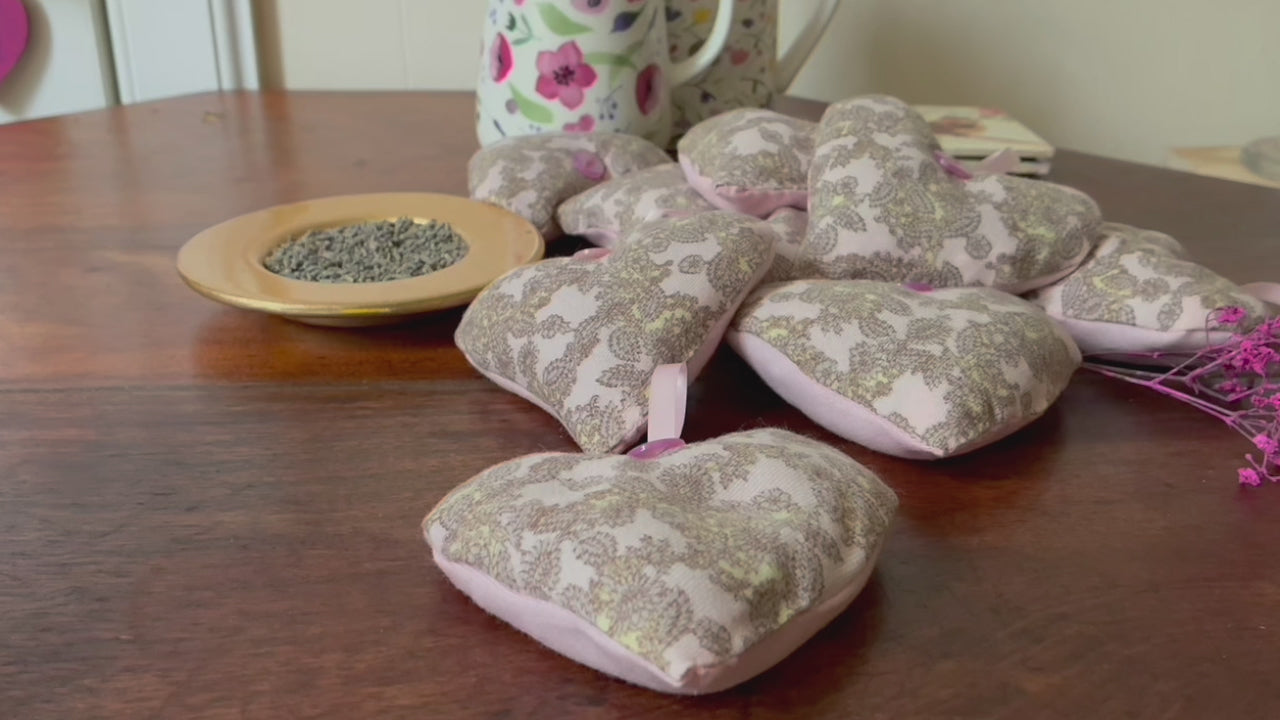 Grey and Pink Paisley Heart Lavender Sachets by a saucer of Dried Lavender 
