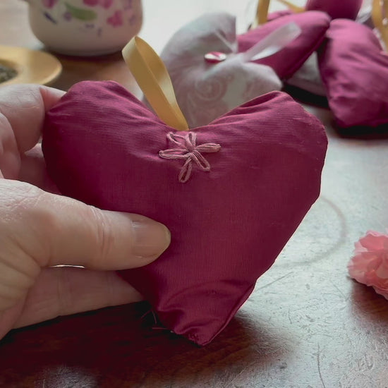 Single Magenta Lavender Sachet with flowers and a bowl of Lavender on a wooden surface