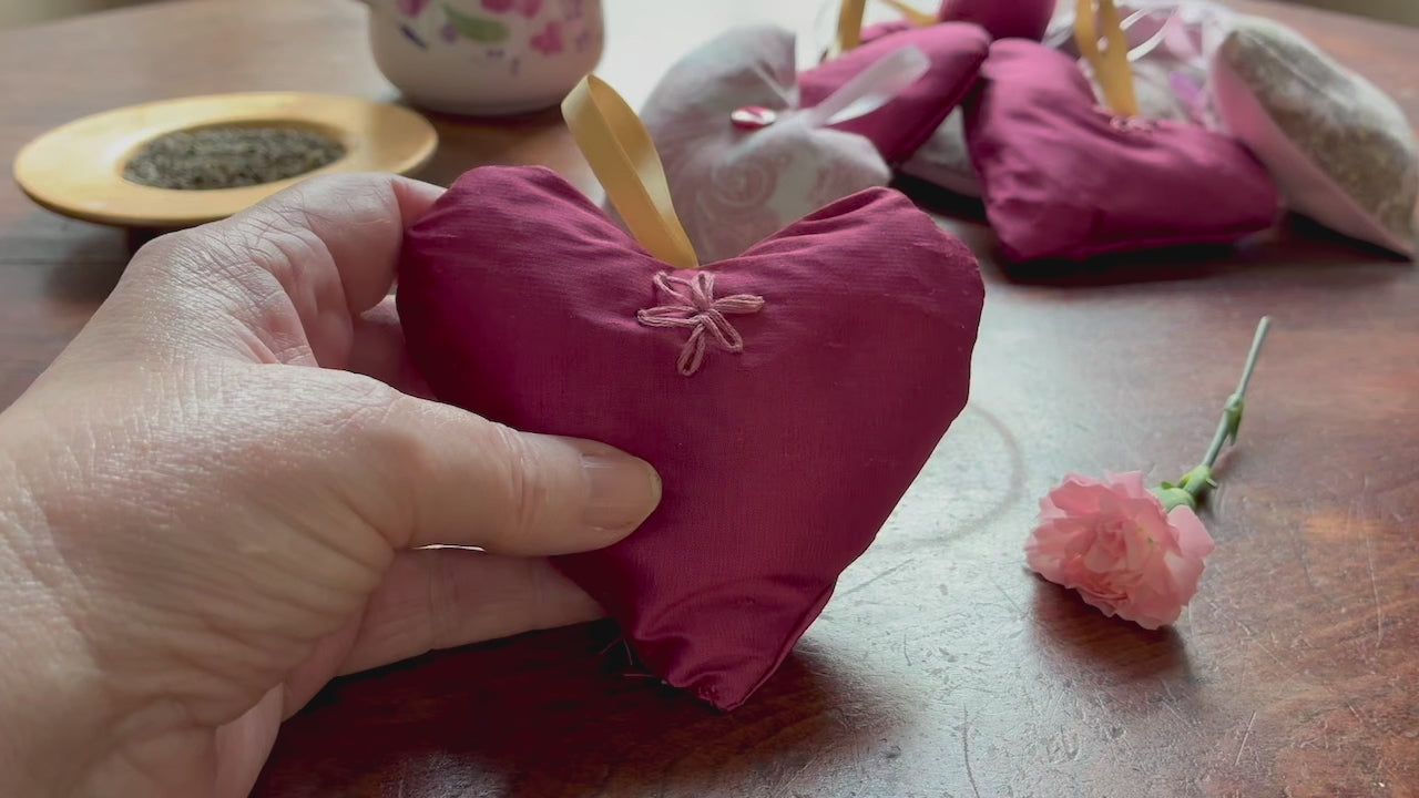 Single Magenta Lavender Sachet with flowers and a bowl of Lavender on a wooden surface