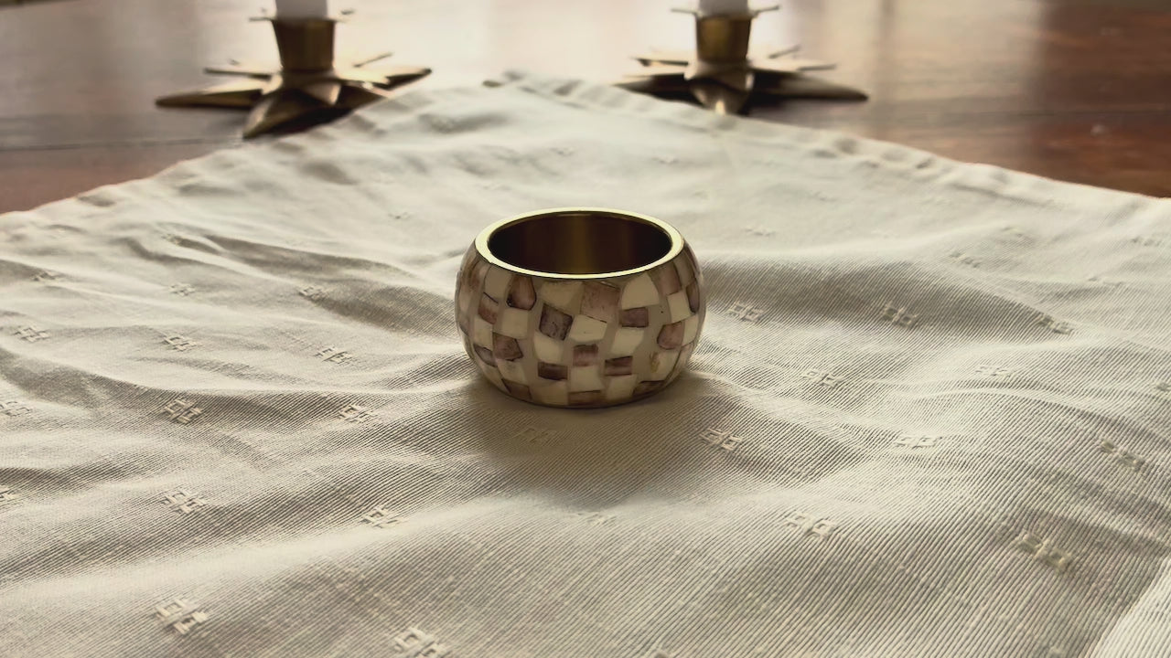 Cream Brocade Napkin by Curlew Crafts being placed in a Napkin Ring