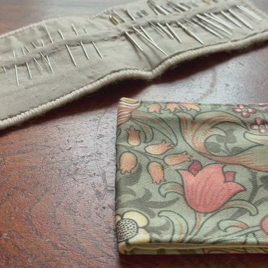 William Morris Needle Case opening and closing on a wooden surface