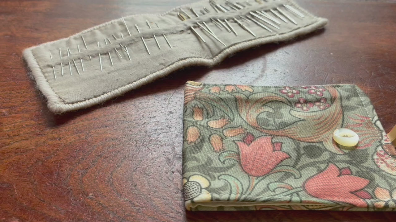William Morris Needle Case opening and closing on a wooden surface