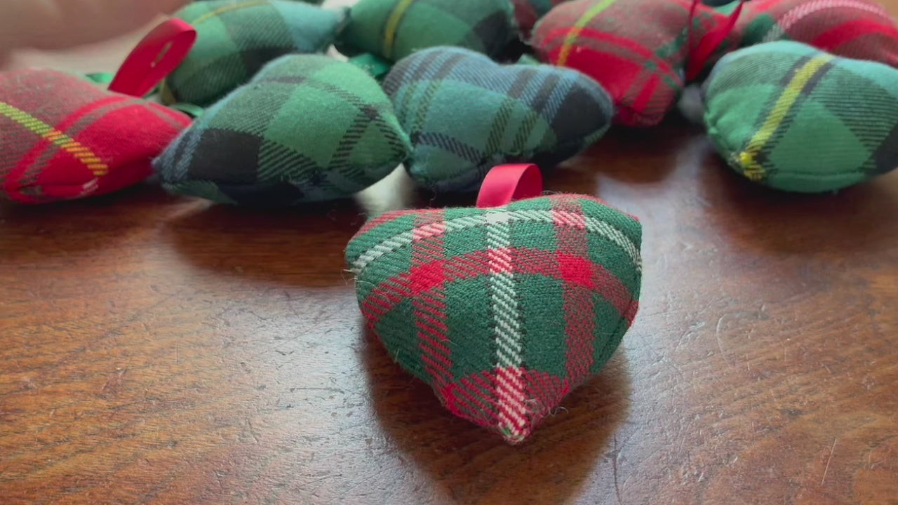 Tartan Heart shaped Pincushion swith Satin ribbon hooks on a wooden surface