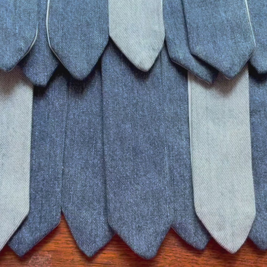 Rows of assorted Denim Bookmarks on a wooden surface