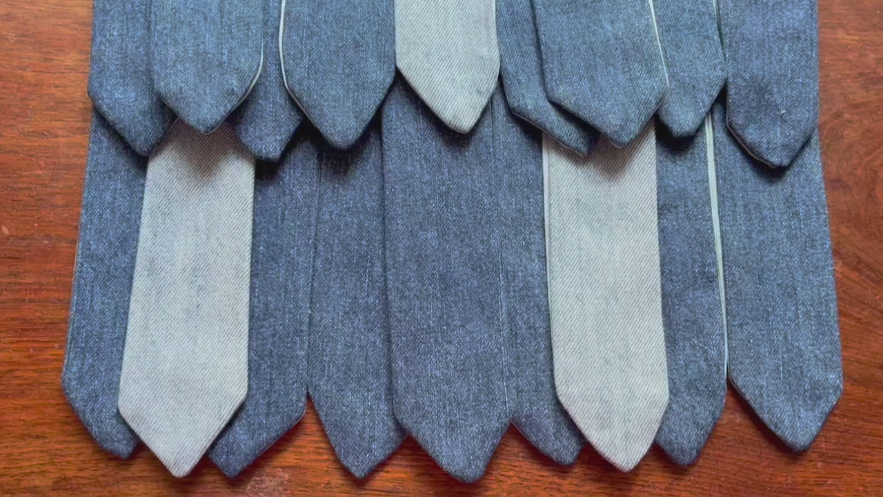 Rows of assorted Denim Bookmarks on a wooden surface