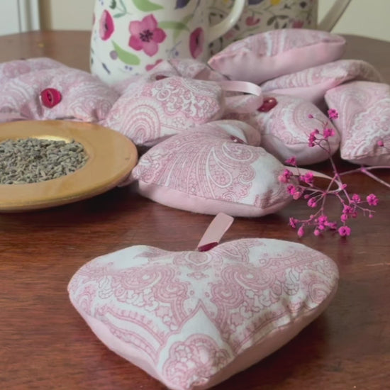 Red and White Paisley Heart shaped Lavender Sachet by some flowery jugs and a saucer of Dried Lavender