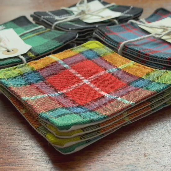 Assorted Sets of 4 Tartan Coasters on a wooden surface