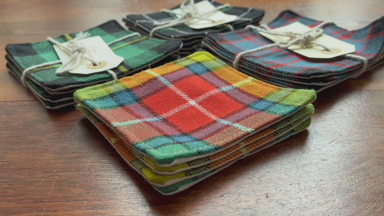 Assorted Sets of 4 Tartan Coasters on a wooden surface