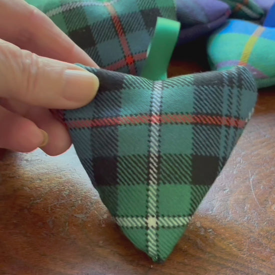Small Tartan Heart Lavender Sachet with a collection of assorted Sachets on a wooden surface