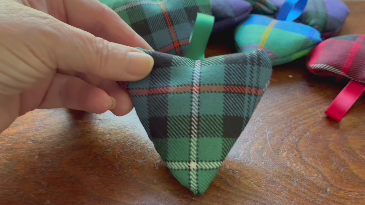 Small Tartan Heart Lavender Sachet with a collection of assorted Sachets on a wooden surface